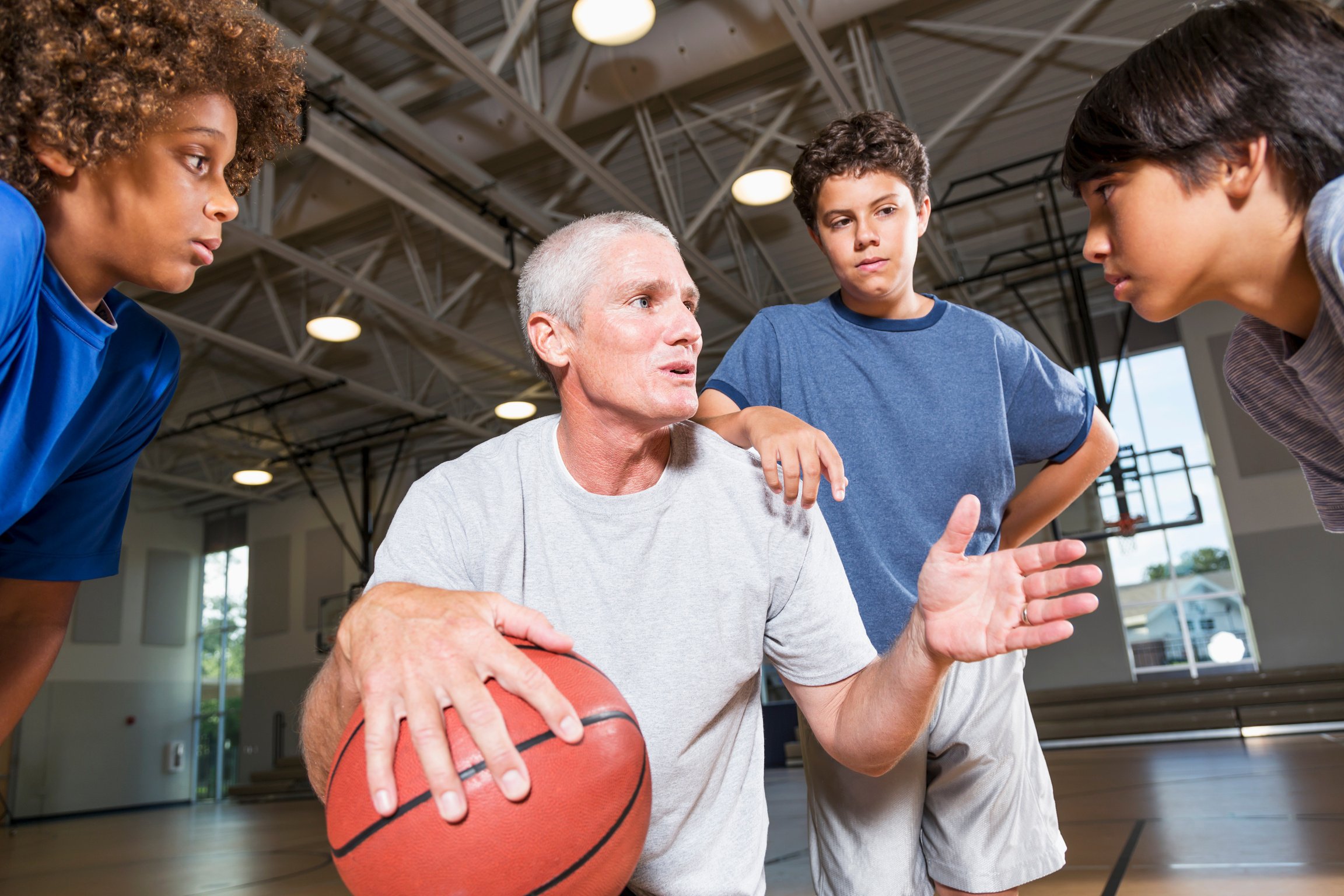 Boys with basketball coach